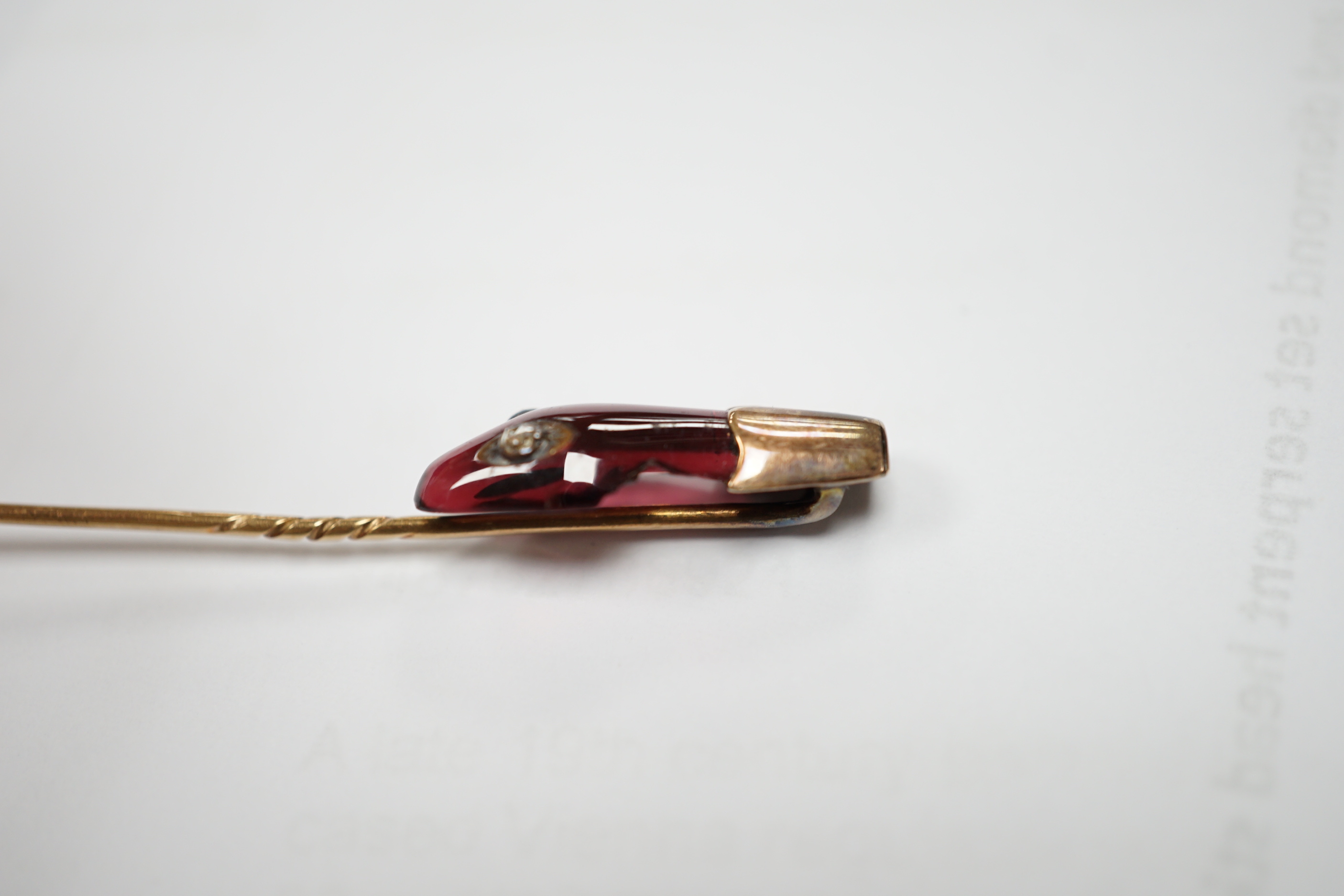 A late Victorian yellow metal, garnet and diamond set serpent head stick pin, 65mm, gross weight 2.9 grams (chip).